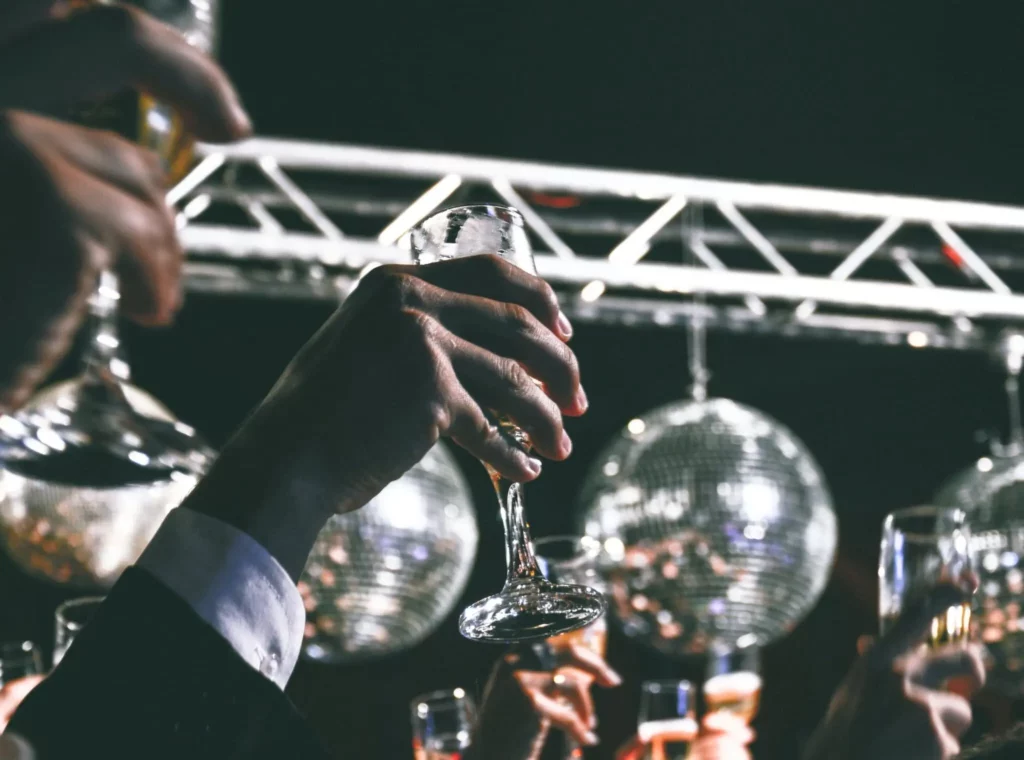 People in crowd toasting